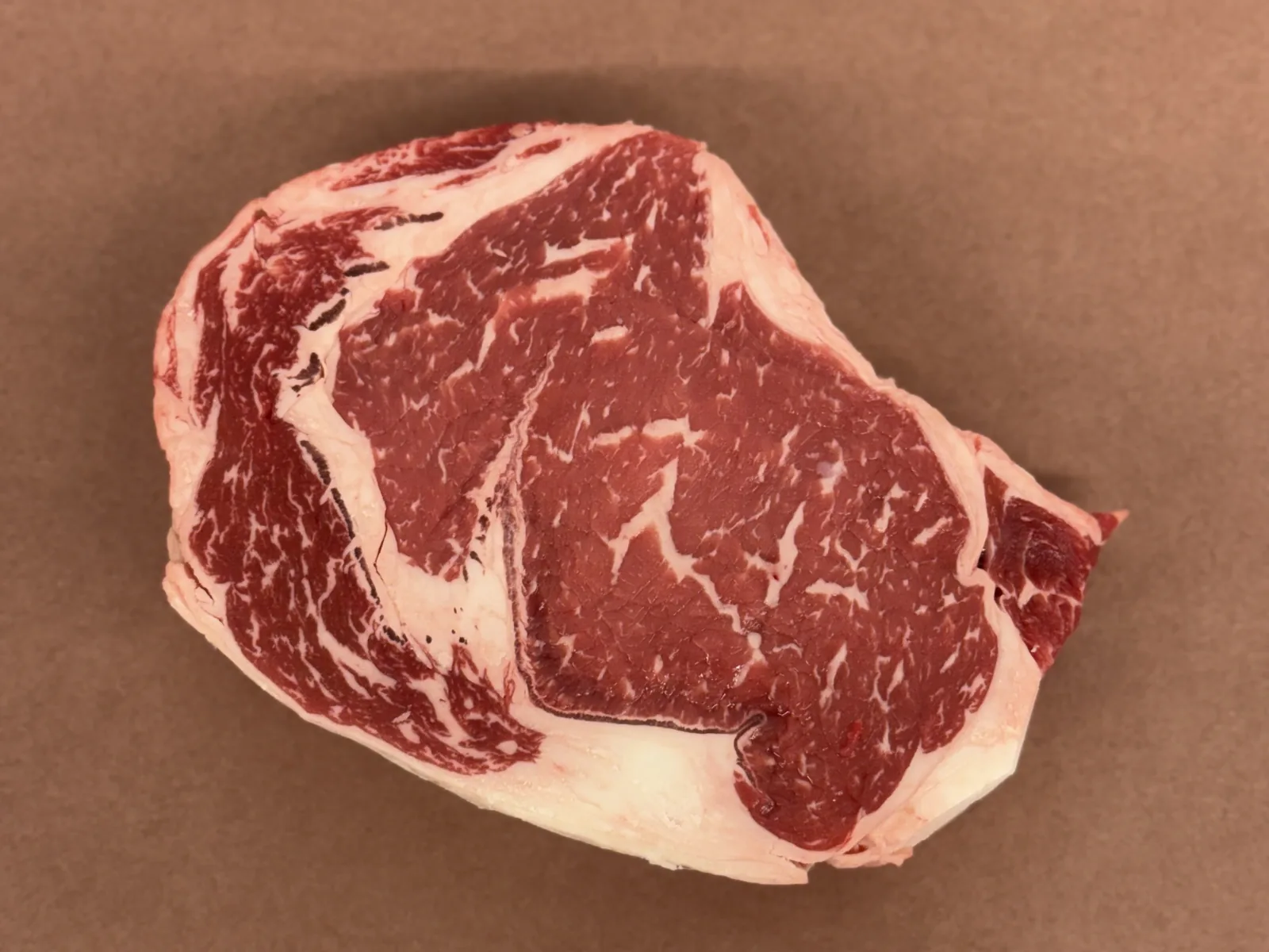 A boneless ribeye steak on butcher paper