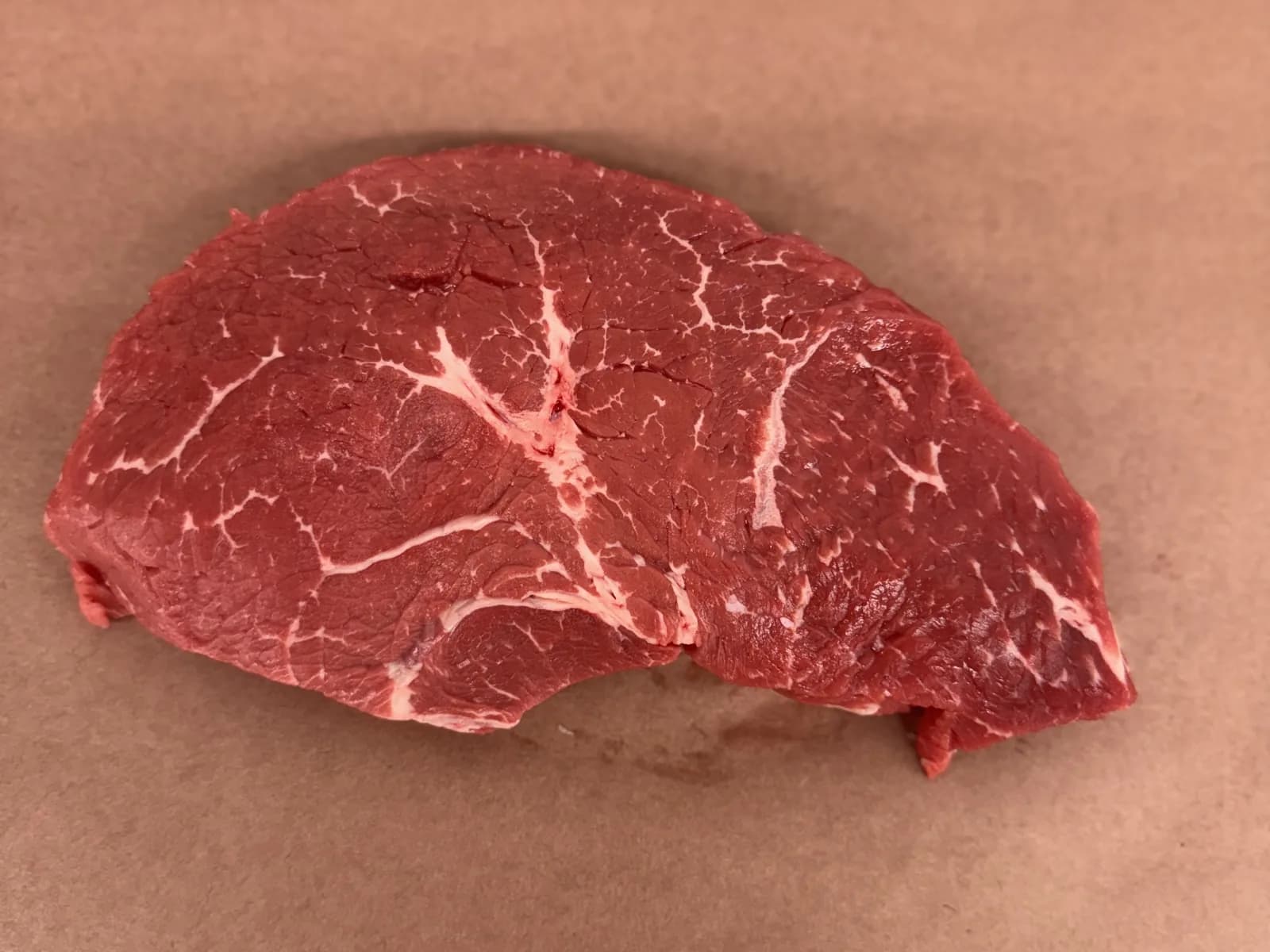 A top sirloin steak on butcher paper